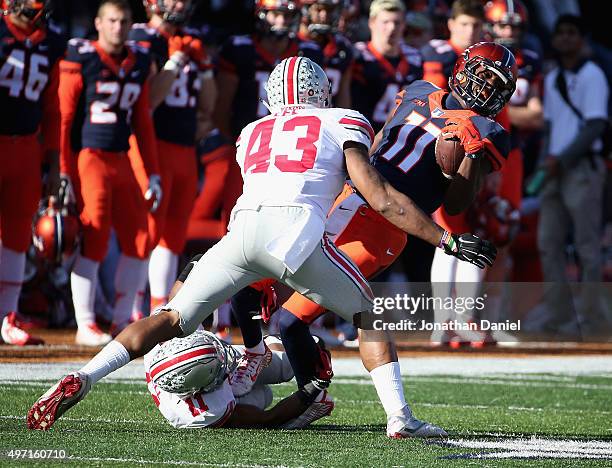 Malik Turner of the Illinois Fighting Illini is tackled by Vonn Bell and Darron Lee of the Ohio State Buckeyes at Memorial Stadium on November 14,...