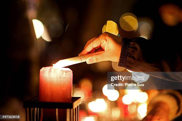 People lite candles at a spontaneous gathering of Parisians at Place de la Republique on November 14, 2015 in Paris, France. At least 120 people have...