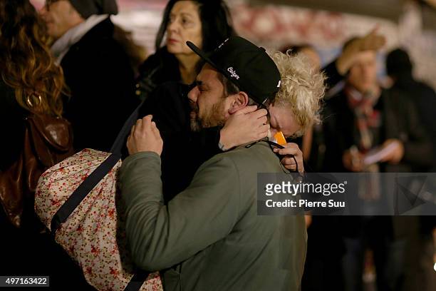 Couple cries in each other's arms at a spontaneous gathering of Parisians at Place de la Republique on November 14, 2015 in Paris, France. At least...