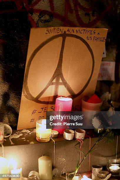 Candles and signs at a spontaneous gathering of Parisians are left at Place de la Republique on November 14, 2015 in Paris, France. At least 120...