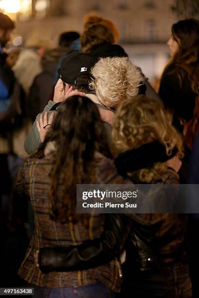 Couple cries in each other's arms at a spontaneous gathering of Parisians at Place de la Republique on November 14, 2015 in Paris, France. At least...