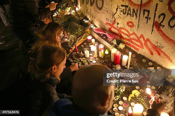 People lay candles and flowers at a spontaneous gathering of Parisians at Place de la Republique on November 14, 2015 in Paris, France. At least 120...