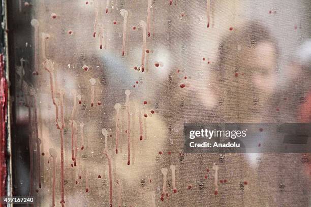 Blood of the victims who lost their lives at Bataclan concert hall and "La Belle Equipe" restaurant is seen on the window in 11th district of Paris,...