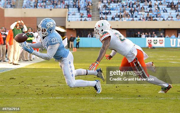 Kendrick Singleton of the North Carolina Tar Heels makes a juggling catch at the goal line as Rayshawn Jenkins of the Miami Hurricanes defends during...