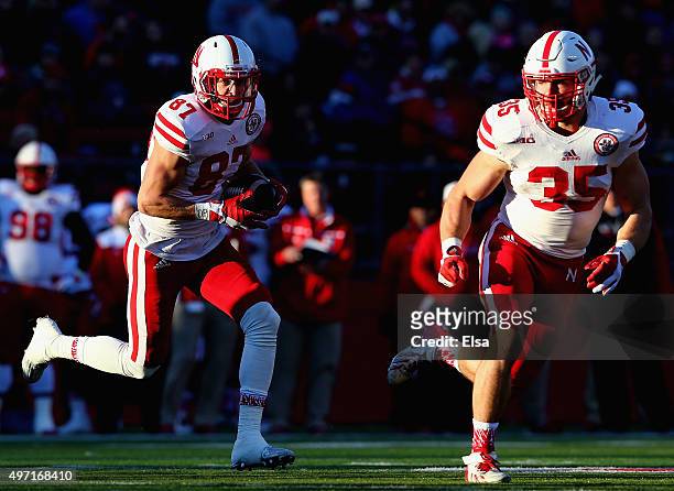 Brandon Reilly of the Nebraska Cornhuskers carries the ball as teammate Andy Janovich blocks in the first quarter against the Rutgers Scarlet Knights...