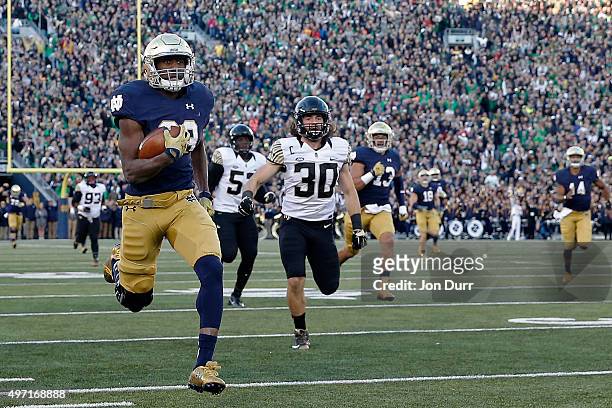 Josh Adams of the Notre Dame Fighting Irish rushes for a 98-yard touchdown against the Wake Forest Demon Deacons during the second quarter at Notre...