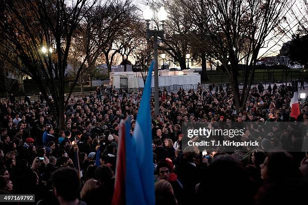 Crowd gathers for a vigil in honor of the victims of terrorist attacks in Paris at Lafayette Square outside the White House on November 14, 2015 in...