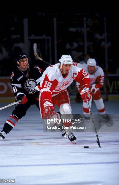 Steve Yzerman of the Detroit Red Wings controls the puck during the game against the Buffalo Sabres at the Joe Louis Arena in Detroit, Michigan. The...