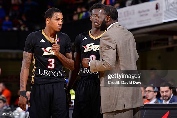 Keith Appling and Myck Kabongo discuss with Anthony Goldwire assistant coach of the Erie BayHawks during the game against the Westchester Knicks at...