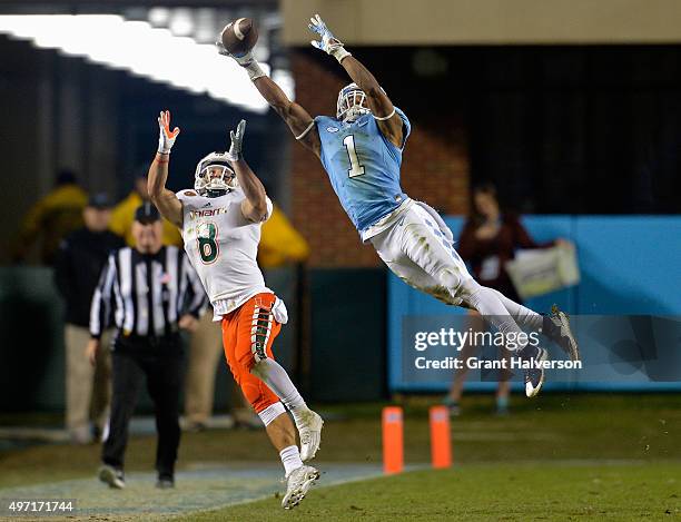 Mike Hughes of the North Carolina Tar Heels breaks up a pass intended for Braxton Berrios of the Miami Hurricanes during their game at Kenan Stadium...