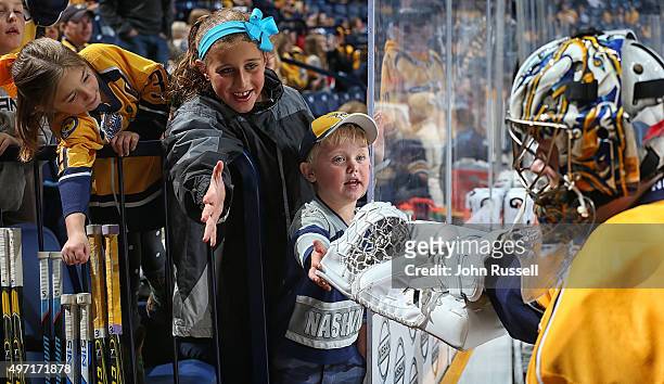 Young fans tap the glove of Marek Mazanec of the Nashville Predators after warmups against the Winnipeg Jets during an NHL game at Bridgestone Arena...