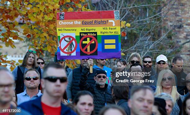 Man holds a protest sign in City Creek Park after many submitted their resignations from the Church of Jesus Christ of Latter-Day Saints in response...