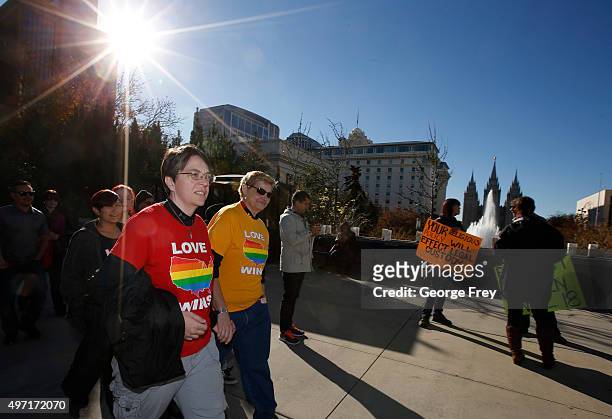 Protesters walk past the historic Mormon temple after many submitted their resignations from the Church of Jesus Christ of Latter-Day Saints in...