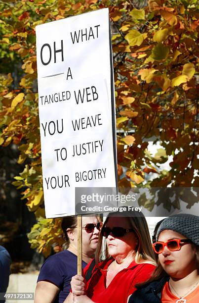 Woman holds a protest sign in City Creek Park after many submitted their resignations from the Church of Jesus Christ of Latter-Day Saints in...