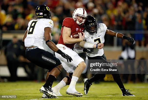 Kevin Hogan of the Stanford Cardinal is hit by Tyree Robinson of the Oregon Ducks but still runs the ball in for a touchdown while Reggie Daniels of...