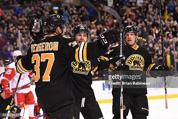 Patrice Bergeron, Brett Connolly and Joonas Kemppainen of the Boston Bruins celebrate a goal against the Detroit Red Wings at the TD Garden on...