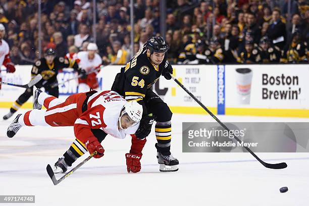 Andreas Athanasiou of the Detroit Red Wings collides with Adam McQuaid of the Boston Bruins during the second period at TD Garden on November 14,...