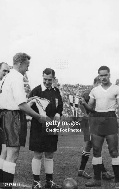 The captains of England and Uruguay, Billy Wright and Matias Gonzales, exchange pennants before an international match at Centenario, 31st May 1953...