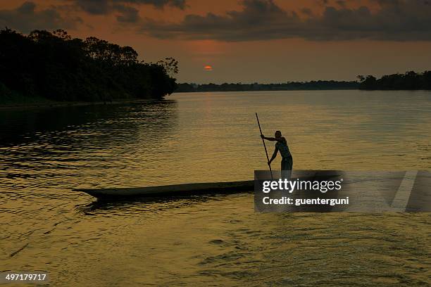 fisherman in a pirogue on the congo river - democratic republic of the congo stock pictures, royalty-free photos & images