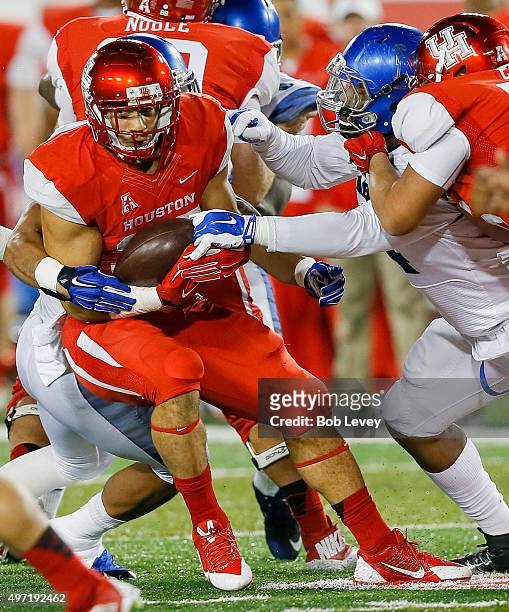 Kenneth Farrow of the Houston Cougars is tackled by the Memphis Tigers in the second quarter on November 14, 2015 in Houston, Texas.
