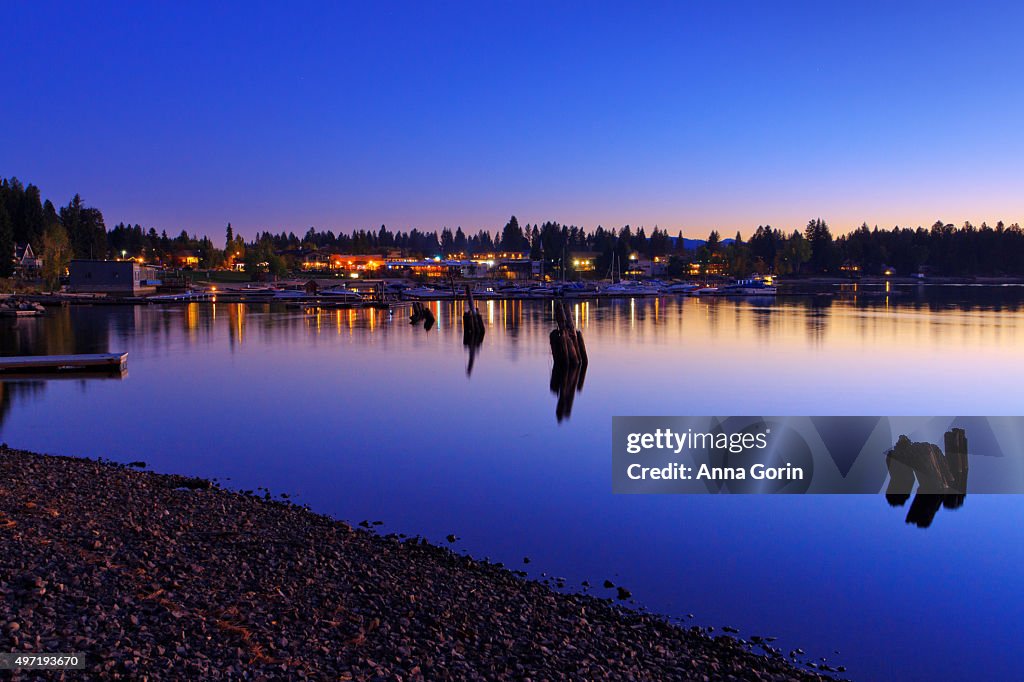 Long exposure of downtown McCall Idaho reflected in Payette Lake at dusk, autumn