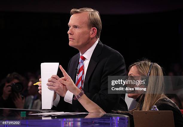 Face the Nation" anchor John Dickerson listens to a crewmember prior to a presidential debate sponsored by CBS at Drake University on November 14,...