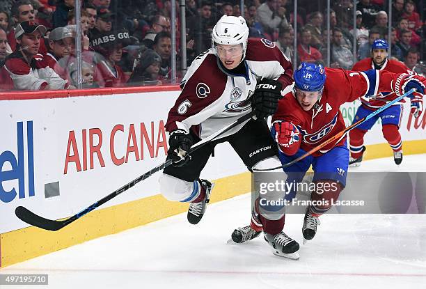 Erik Johnson of theColorado Avalanche controls the puck while being challenged by Brendan Gallagher of the Montreal Canadiense in the NHL game at the...