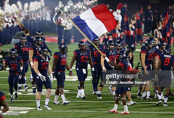 Cornerback DaVonte' Neal of the Arizona Wildcats waves the French flag prior to the game against the Utah Utes at Arizona Stadium on November 14,...