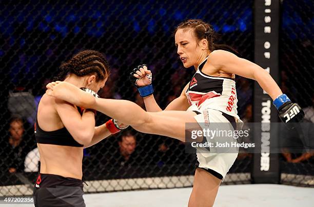 Valerie Letourneau lands a left-leg kick against Joanna Jedrzejczyk in their UFC women's strawweight championship bout during the UFC 193 event at...