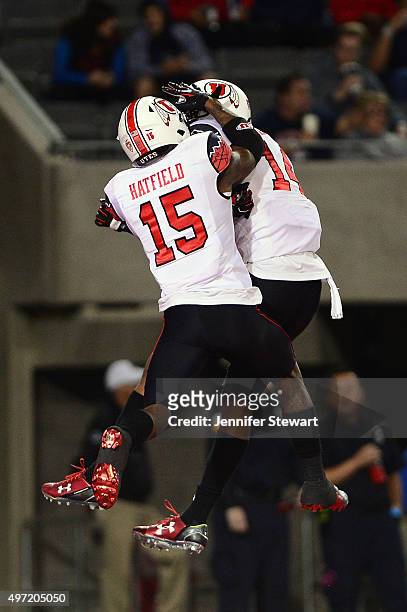 Defensive back Brian Allen of the Utah Utes celebrates with teammate defensive back Dominique Hatfield after Allen intercepts the football in the...