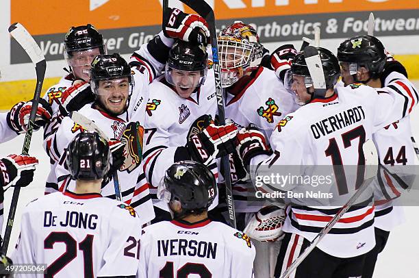 Blake Heinrich, Paul Bittner and goaltender Adin Hill of the Portland Winterhawks celebrate their teams win over the Vancouver Giants after their WHL...