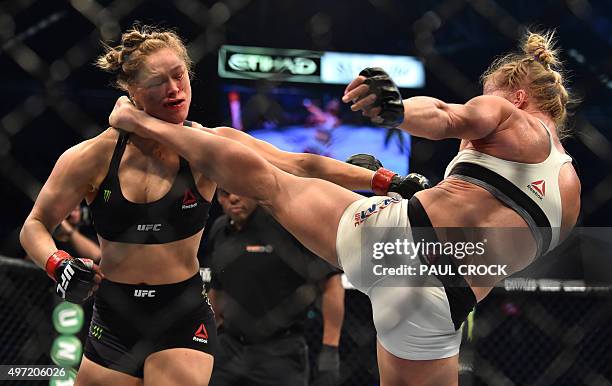 Holly Holm of the US lands a kick to the neck to knock out compatriot Ronda Rousey and win the UFC title fight in Melbourne on November 15, 2015....