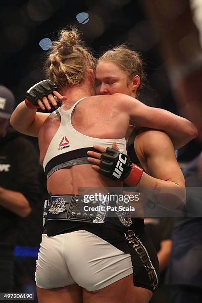 Holly Holm of the United States embraces Ronda Rousey of the United States following their UFC women's bantamweight championship bout during the UFC...