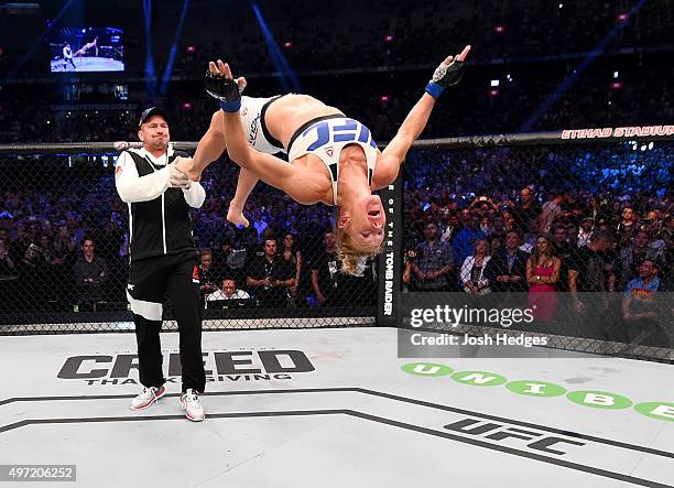 Holly Holm does a back-flip in celebrateion of her second round KO over Ronda Rousey to win their UFC women's bantamweight championship bout during...