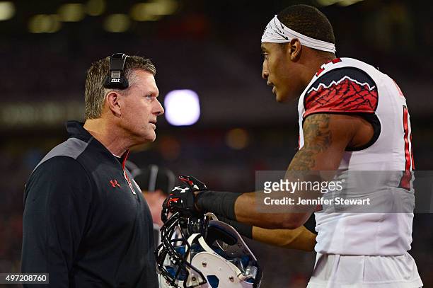 Defensive back Brian Allen of the Utah Utes talks with head coach Kyle Whittingham on the sidelines in the game against the Arizona Wildcats at...