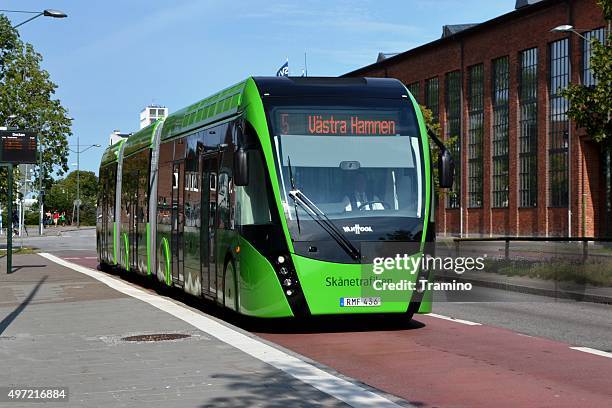 van hool exqui.city tram-bus on the road - biogas stock pictures, royalty-free photos & images