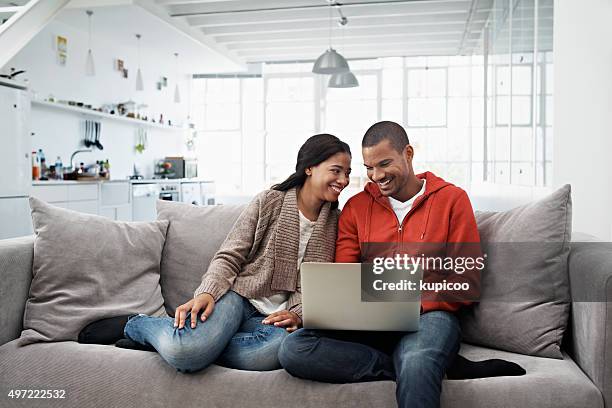 living life wirelessly - young couple laptop stock pictures, royalty-free photos & images