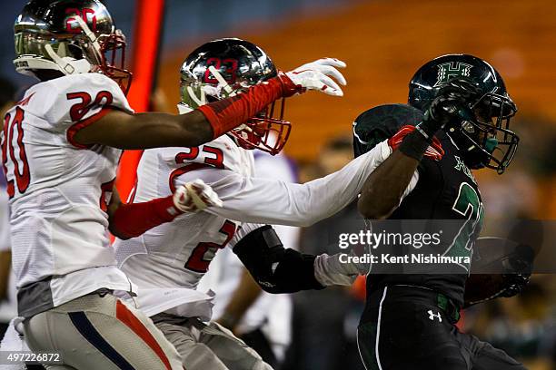 Paul Harris of the Hawaii Warriors is forced out of bounds by Malcolm Washington and Alan Wright of the Fresno State Bulldogs during the second half...