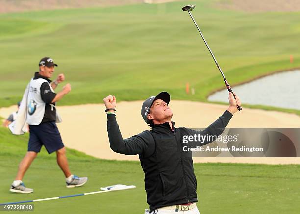 Kristoffer Broberg of Sweden and his caddie John Dempster celebrate on the first play-off hole after winning the BMW Masters at Lake Malaren Golf...