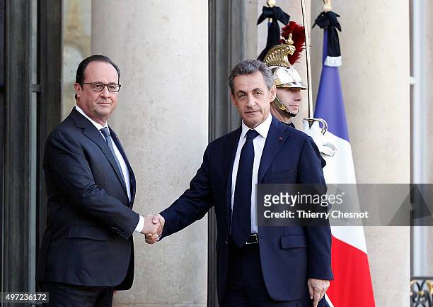 French President Francois Hollande welcomes right-wing Les Republicains party's President and former French president Nicolas Sarkozy at the...