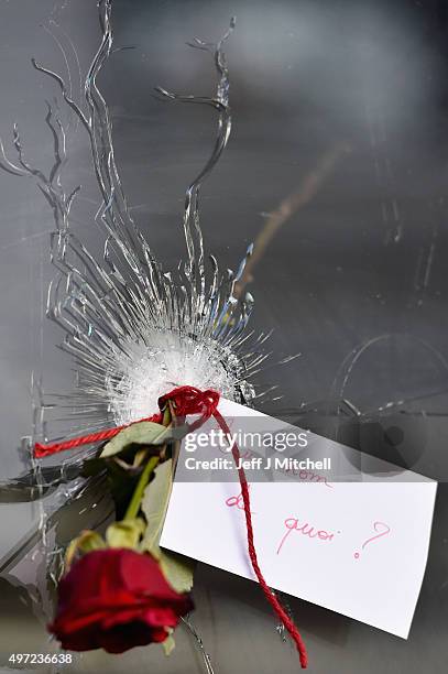 Rose is placed beside a bullet hole at La Belle Equipe restaraunt on Rue de Charonne following Fridays terrorist attack on November 15, 2015 in...