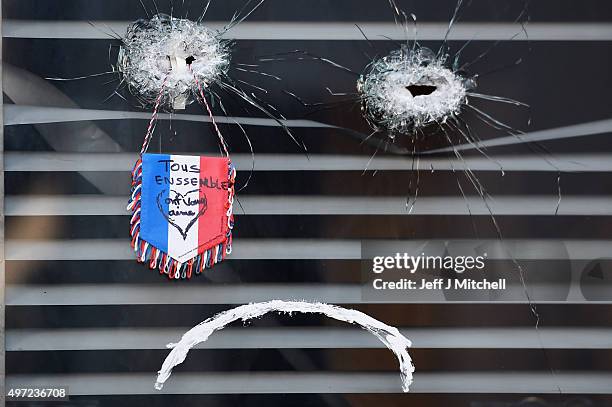 Rose is placed beside a bullet hole at La Belle Equipe restaraunt on Rue de Charonne following Fridays terrorist attack on November 15, 2015 in...