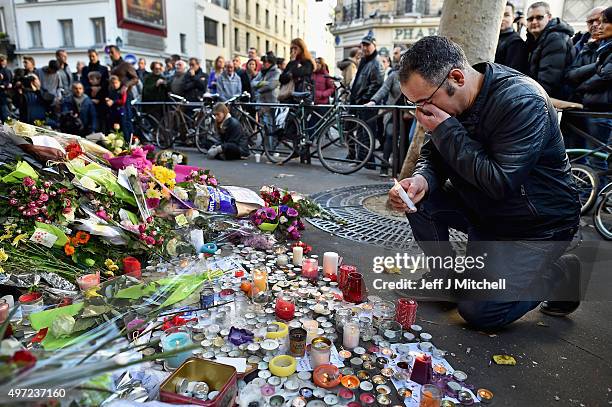 Members of the public gather to lay flowers and light candles at La Belle Equipe restaraunt on Rue de Charonne following Fridays terrorist attack on...
