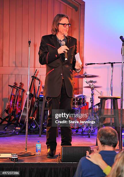 Scott Goldman, Vice President of the GRAMMY Foundation and MusiCares auctions off items at the GRAMMY Foundation house concert featuring The Band...