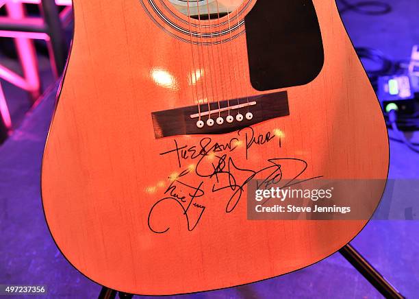 An autographed guitar by The Band Perry is auctioned off at the GRAMMY Foundation house concert featuring The Band Perry at Trattore Farms on...