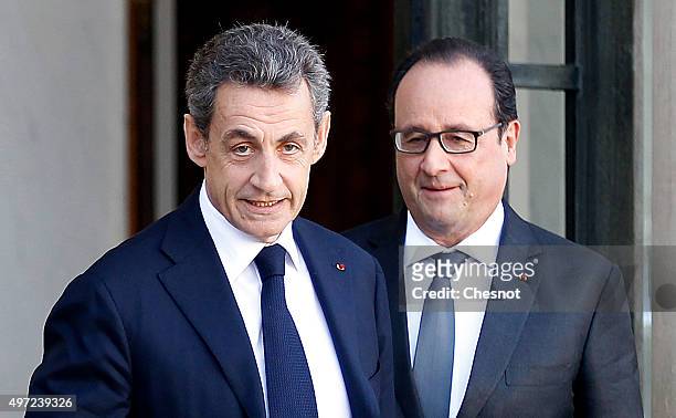 French President Francois Hollande accompanies right-wing Les Republicains party's President and former French President Nicolas Sarkozy after their...