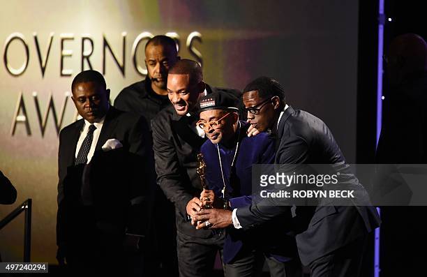 Actors Will Smith and Wesley Snipes pose with director Spike Lee after Lee was presented with an honorary Oscar award, during the 7th annual...