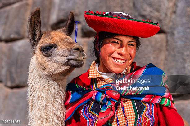 peruvian girl wearing national clothing posing with llama near cuzco - lama stockfoto's en -beelden