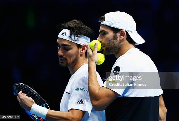 Simone Bolelli and Fabio Fognini of Italy talk in their men's doubles match against Jamie Murray of Great Britain and John Peers of Australia during...