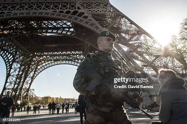 French soldier stands guard at Eiffel Tower on November 15, 2015 in Paris, France. As France observes three days of national mourning members of the...